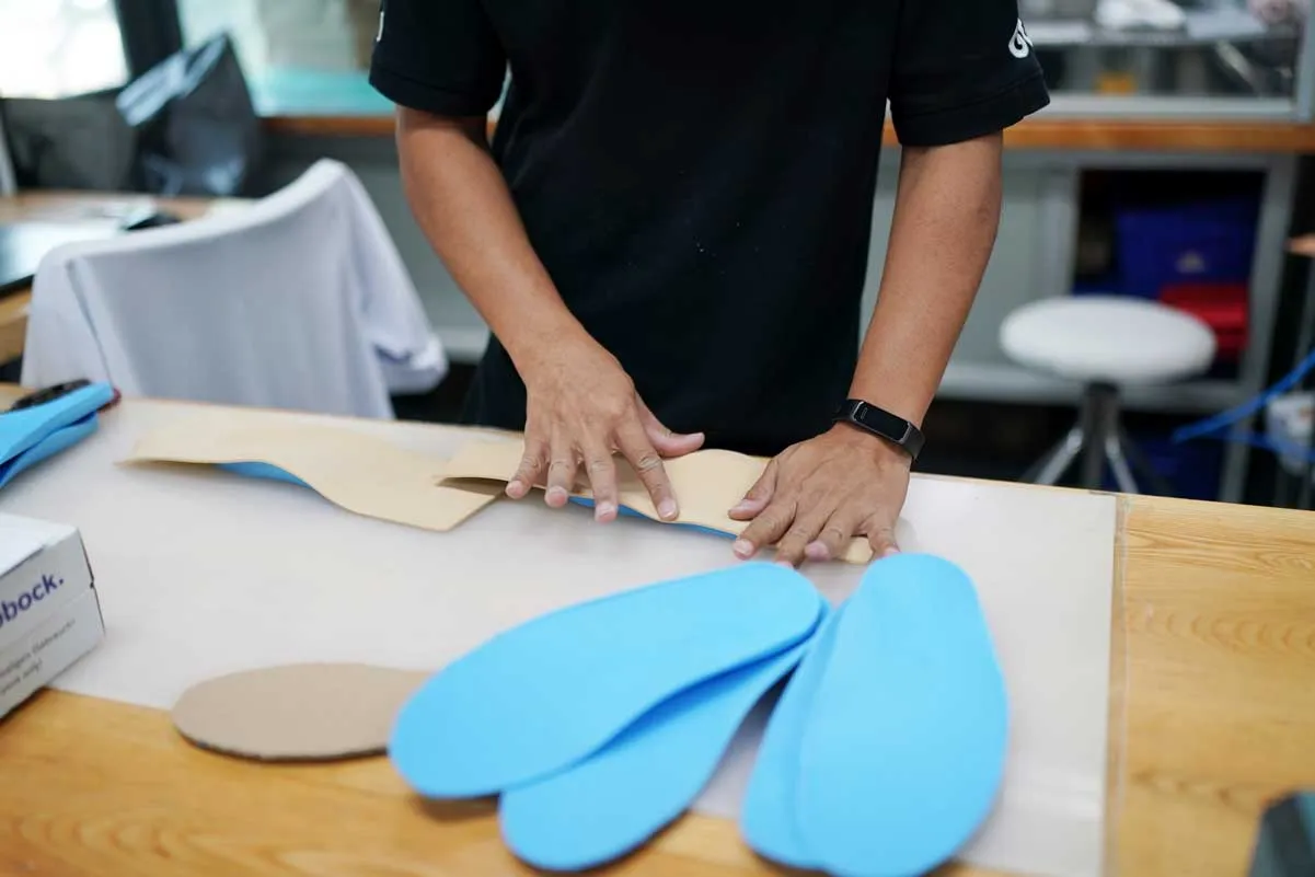 orthopedic technician making prosthetic leg for